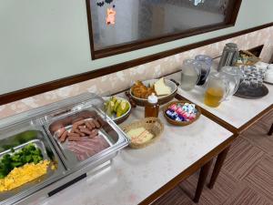 einen Tisch mit Lebensmitteln und anderen Lebensmitteln darauf in der Unterkunft 高嶺荘 in Otari