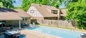 a house with a swimming pool in the yard at Heart of Tulsa, pool, game room, Sleeps 8 in Tulsa