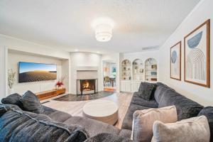 a living room with a couch and a fireplace at Heart of Tulsa, pool, game room, Sleeps 8 in Tulsa