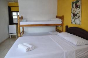 Giường trong phòng chung tại Suíte Tropicália +9 ảnh