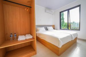 a bedroom with a bed and a window at Naava Village in Tagalbato +45 photos