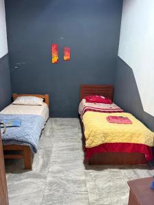 En eller flere senge i et værelse på Chacra Los Nietos
