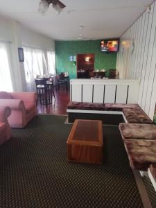 a living room with a couch and a table at Hotel Lincoln in Villa Gesell