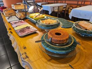 a table with many different types of food on it at Atalaia Palace Hotel in Guarapuava