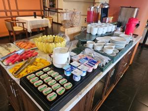 a buffet with many different types of food on a table at Atalaia Palace Hotel in Guarapuava