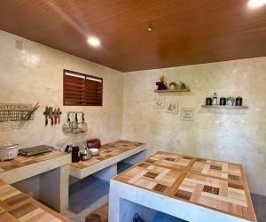 a kitchen with wooden counter tops in a room at Violegre Homestay - KABLON in General Luna