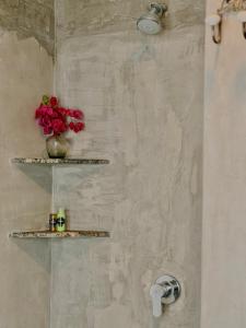 a bathroom with shelves and a vase of flowers on the wall at Luvora Villa in Ambalangoda +9 photos