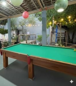 a pool table in a living room with a pool at Garden JP in João Pessoa