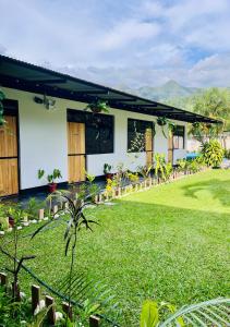 a house with a lawn in front of it at La Posada de Chango in La Merced