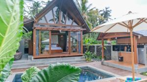 a villa with a swimming pool and a house at Sanis House in Penginyahan