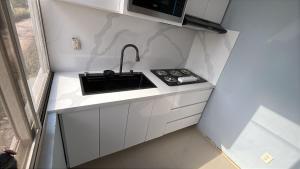 a small kitchen with a sink and a microwave at Cuarto Privado in Arandas