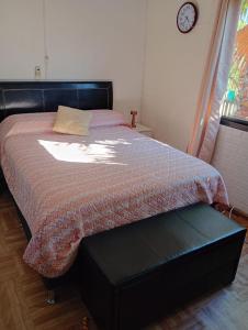 a bedroom with a bed with a black foot board at Eternal Sun in Balneario Buenos Aires