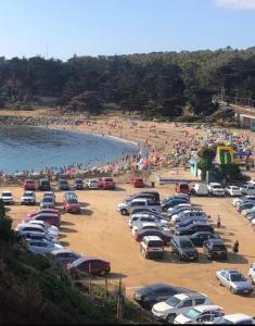 a bunch of cars parked in a parking lot at a beach at El tabo house in El Tabo