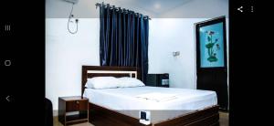 a bedroom with a bed and a black curtain at MoExoticRoyaleServices in Ikorodu