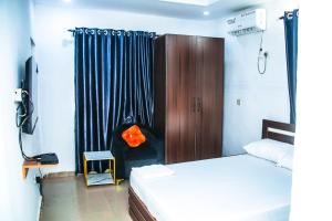 a bedroom with a bed and a black curtain at MoExoticRoyaleServices in Ikorodu