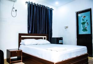 a bedroom with a bed with a black curtain at MoExoticRoyaleServices in Ikorodu