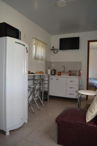 a kitchen with a white refrigerator in a room at Orejano in Mercedes +6 photos