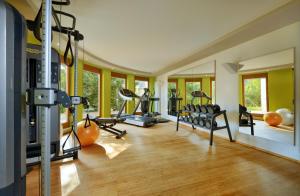 a gym with several treadmills and machines in a room at Landhotel RÖSSLE in Stimpfach