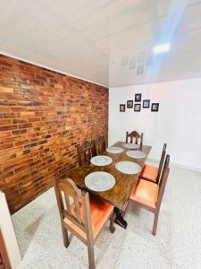 a dining room with a wooden table and chairs at Casa Nobsa ArteSana in Nobsa