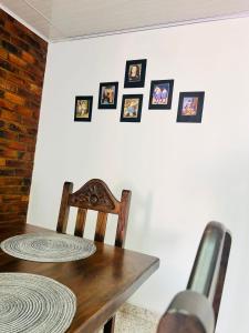 a table with a chair and pictures on a wall at Casa Nobsa ArteSana in Nobsa +2 photos