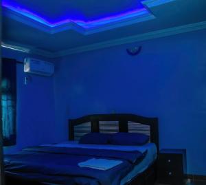 a blue room with a bed with blue lights at MoExoticRoyaleServices in Ikorodu