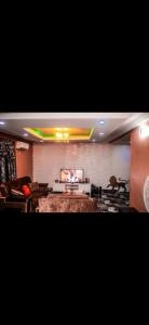 a living room with a couch and a tv at MoExoticRoyaleServices in Ikorodu