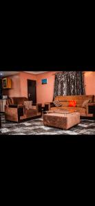 a living room with couches and a tv at MoExoticRoyaleServices in Ikorodu