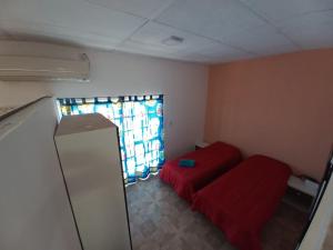 a room with a red couch and a window at Departamento LA PALMERA ARGENTINA in San Luis