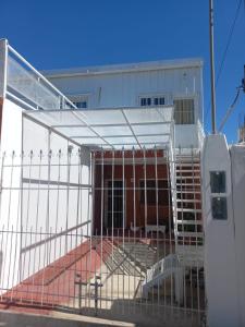 a building with a fence in front of it at Departamento LA PALMERA ARGENTINA in San Luis