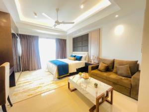 a hotel room with a bed and a couch at Studio apartment ocean breeze in Negombo