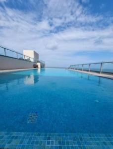 a swimming pool on top of a building with blue water at Studio apartment ocean breeze in Negombo