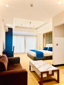 a hotel room with two beds and a couch at Studio apartment ocean breeze in Negombo