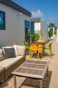 a patio with a couch and a table and chairs at Mosch Apartments in Noord