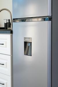 a stainless steel refrigerator in a kitchen at Mosch Apartments in Noord