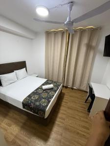 En eller flere senge i et værelse på GRAND HOTEL ViLLA ROSA