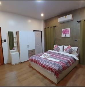 a bedroom with a large bed in a room at River Bend Villas in Mae Rim