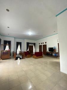 a large living room with couches and a table at Homestay loteng in Madasari