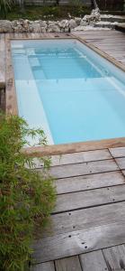 a large swimming pool on a wooden deck at Breeze Ocean Bungalow Moorea in Moorea