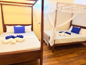 Postel nebo postele na pokoji v ubytování Wilpattu Greenheart Resort