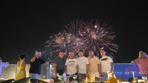 a group of people standing in front of a fireworks display at Hotel Dell' Alba in Phú Quốc