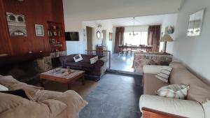a living room with two couches and a table at Chalet de campo in Piriápolis