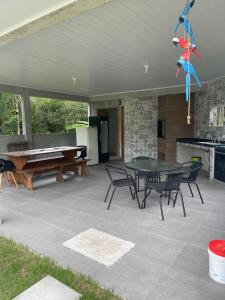 a patio with a ping pong table and chairs at Chácara Quinta do Sol in Antonina