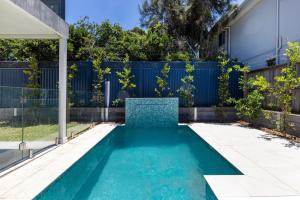 a swimming pool in the backyard of a house at Bellagio - Swimming Pool with Ocean Views in Callala Beach