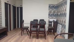 a group of chairs and a table in a room at Rampriya Service Apartment in Nagpur