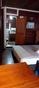 a room with two beds and a table and a mirror at casa frisas del mar in Bocas Town