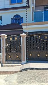 a building with a black gate with gold decorations at Constanza Family House in Constanza