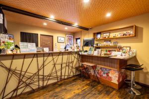 a store with a counter and a bar in a room at Guest House Ouka in Takayama