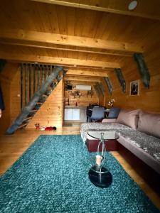 a living room with a couch and a rug at Tara lux in Mojkovac