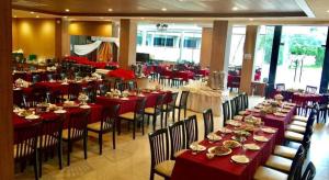 une salle à manger avec des tables, des chaises et un tissu de table rouge dans l'établissement The Impress Nan Hotel, à Ban Du Nua (1)
