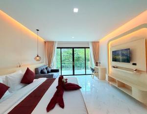 a large bedroom with a large bed and a tv at Pure Sand Lanta Resort in Ko Lanta